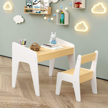 Children's table and chairs set in a room with decorative elements on the wall.