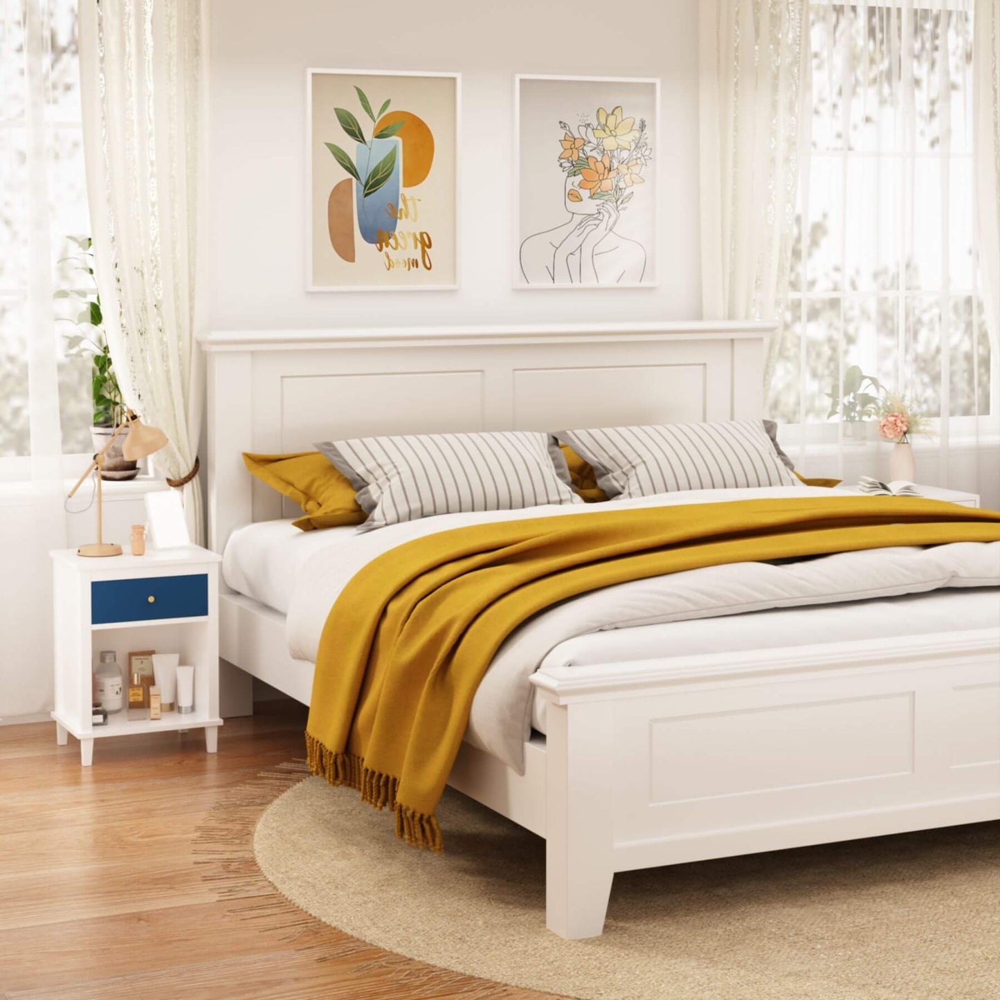 White bedroom with a bed, nightstands, and wall art