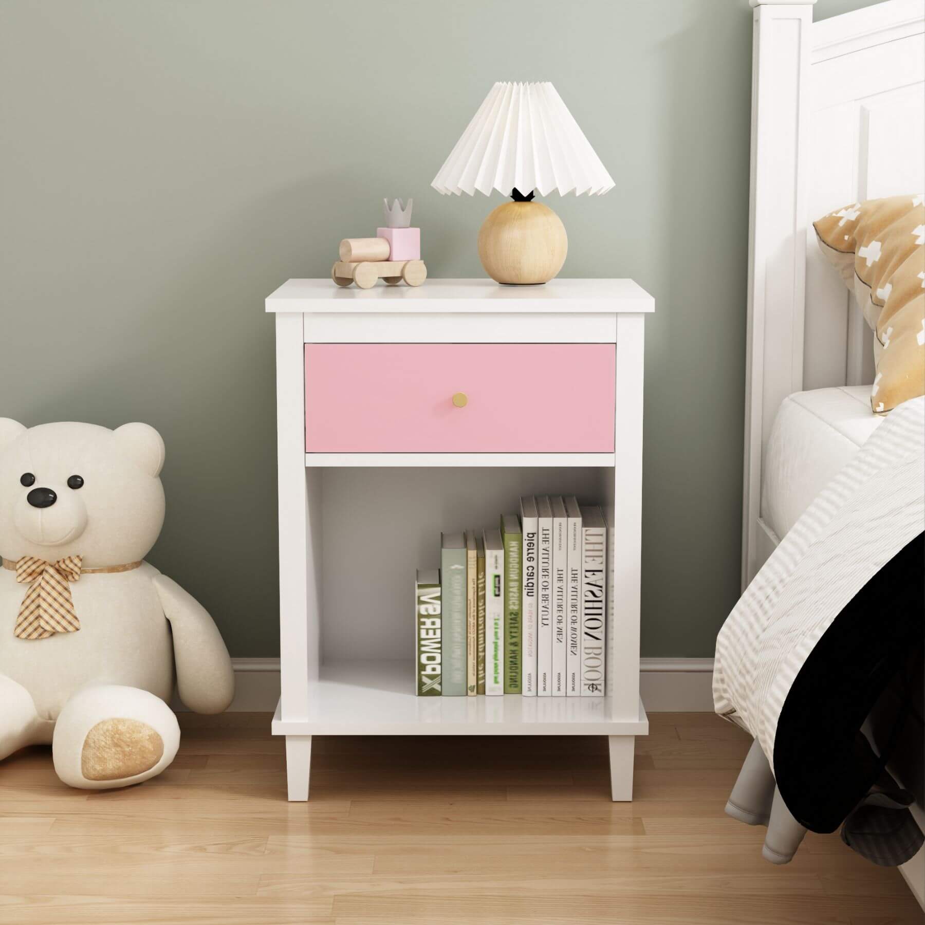 MOONRIVER Golden Handle Wooden Nightstand - Pink next to a teddy bear and books in a bedroom setting.