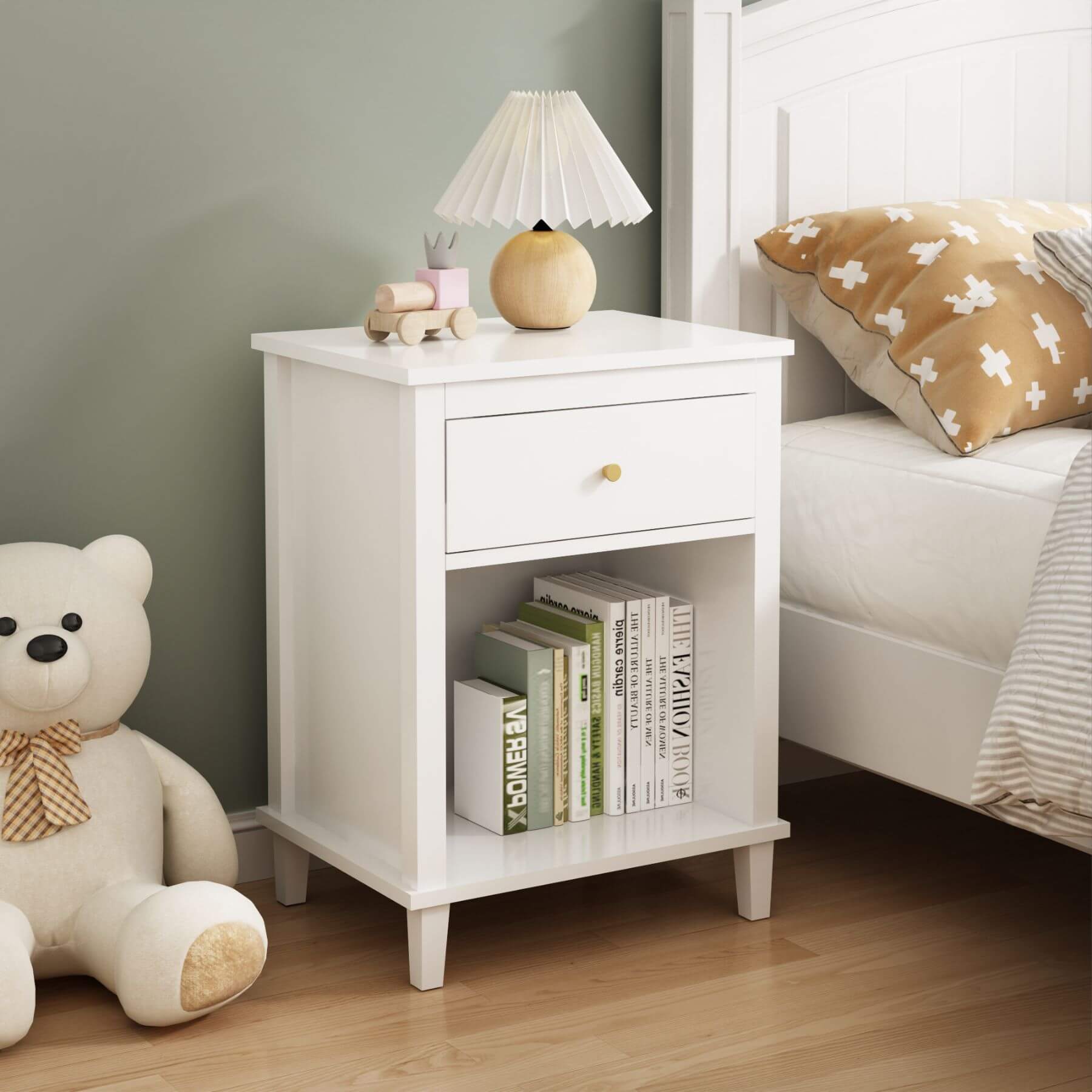 MOONRIVER Golden Handle Wooden Nightstand - White with books and a lamp next to a teddy bear on a wooden floor.