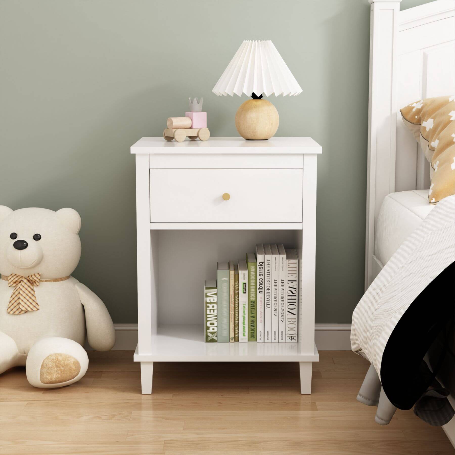 MOONRIVER Golden Handle Wooden Nightstand - White with books and a lamp next to a teddy bear and bed.