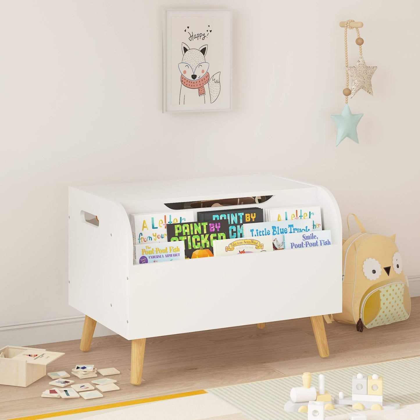 White toy storage box with books and toys in a child's room