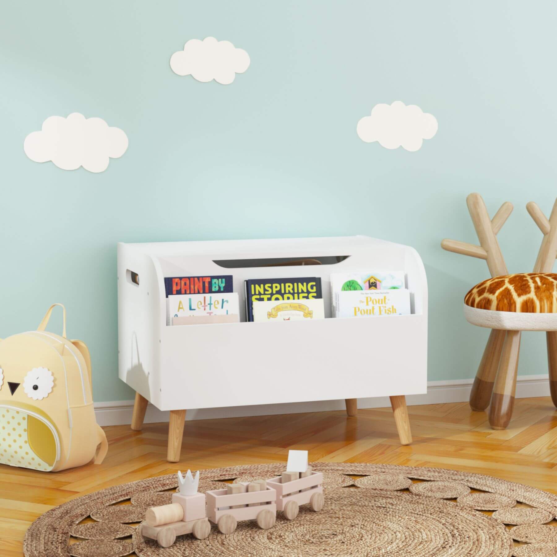 Children's room with MOONRIVER Wooden Toy Box - White, books, and toys against a light blue wall with cloud decorations.