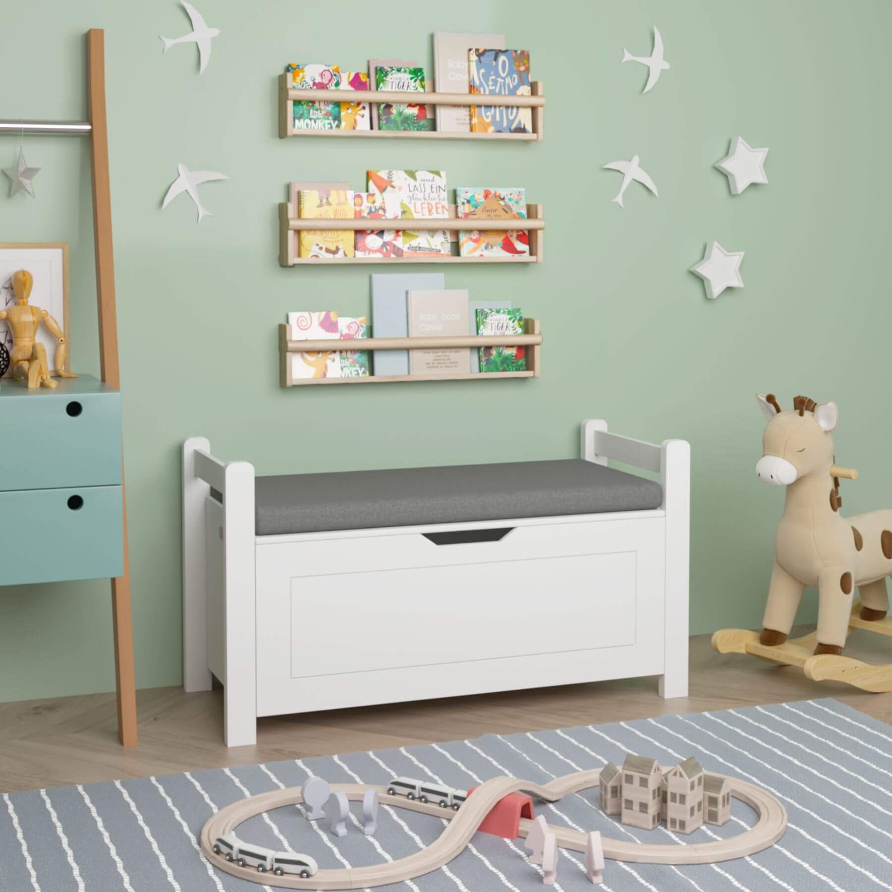 Children's room with MOONRIVER Kids Toy Box Chest, toy train set, and books on shelves.