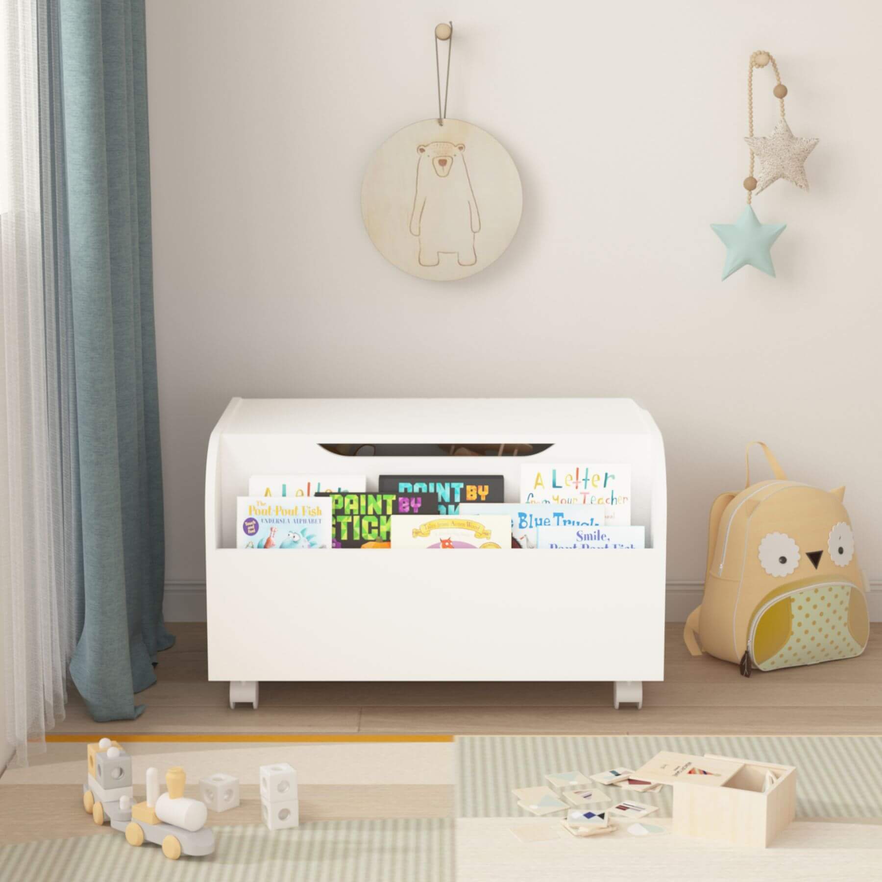 White storage unit with children's books in a room with toys and decor