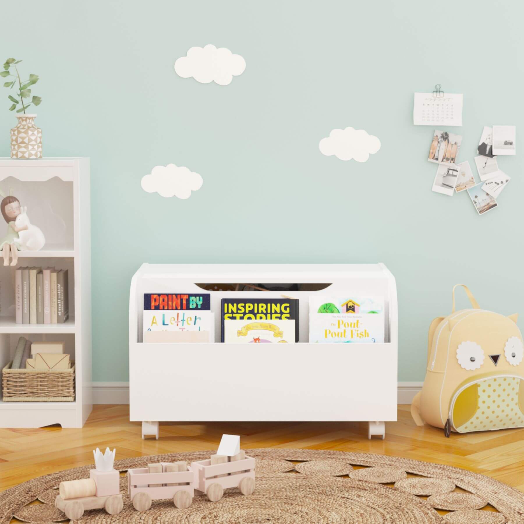Children's room with a white toy storage box, books, and toys on a wooden floor.