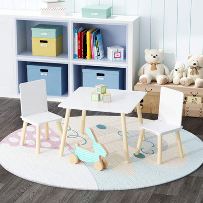 Children's playroom with MOONRIVER Wooden Kids Table and 2 Chairs Set - White, toys, and storage boxes.