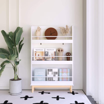White bookshelf with decorative items against a white wall, next to a potted plant.