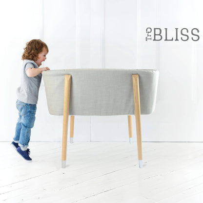 Kid Looking into TruBliss SOVA Bassinet Grey