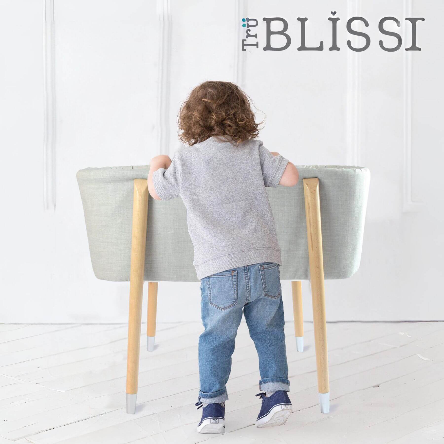 Kid Looking into TruBliss SOVA Bassinet Grey