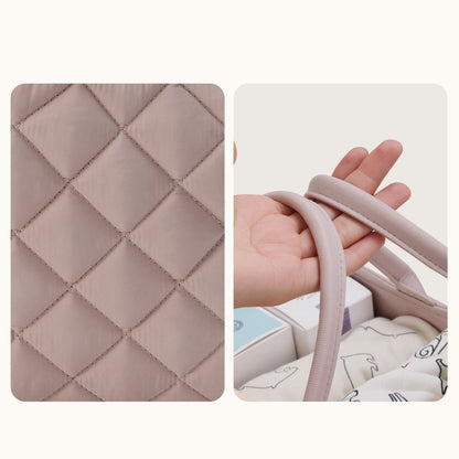 Quilted fabric with diamond pattern and a hand holding a soft, pinkish-brown handle.