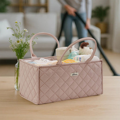 Sunveno Quilted Diaper Caddy Organizer - Brown on a wooden surface with a blurred background of a living room.