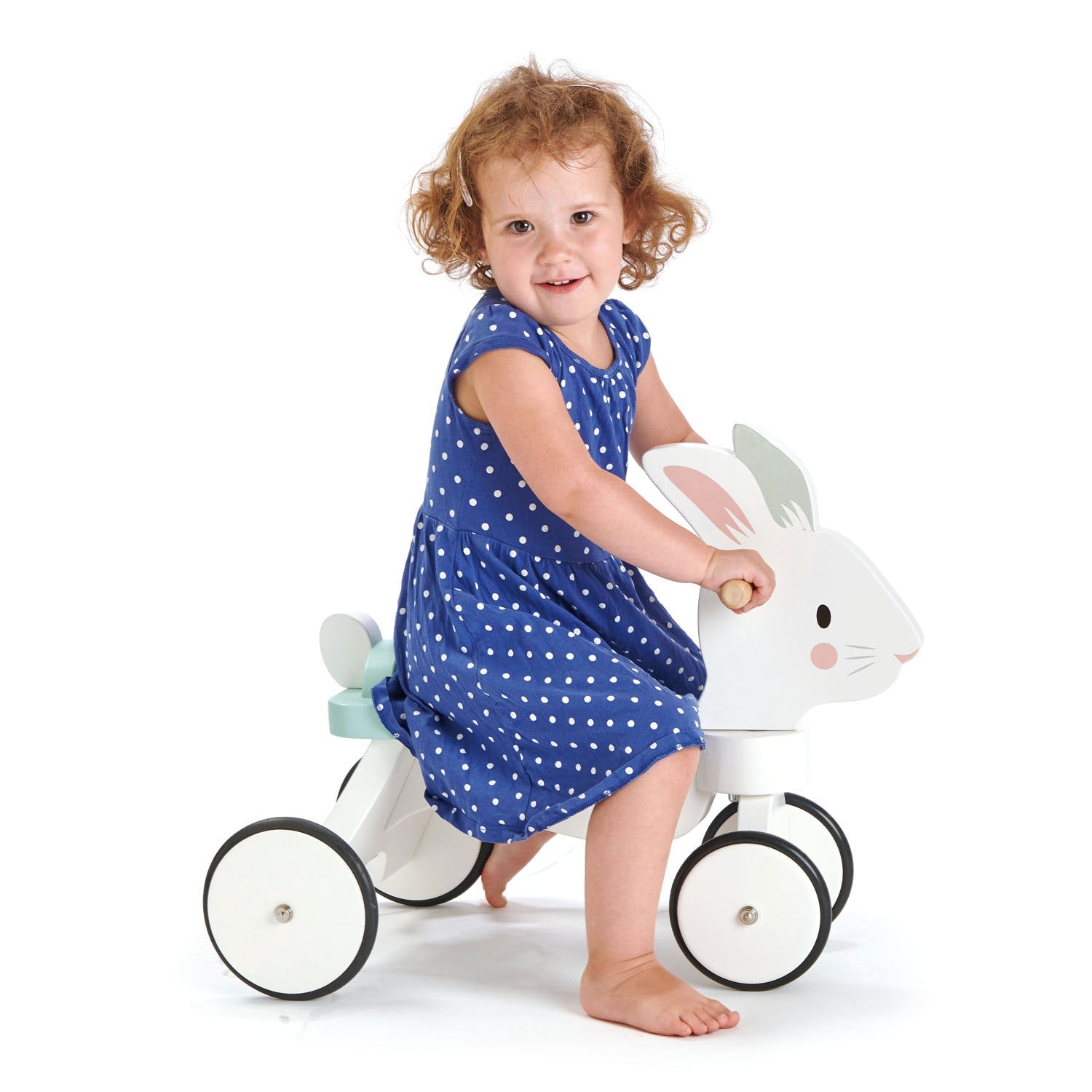 Child in a blue dress riding Tender Leaf Running Rabbit Ride On