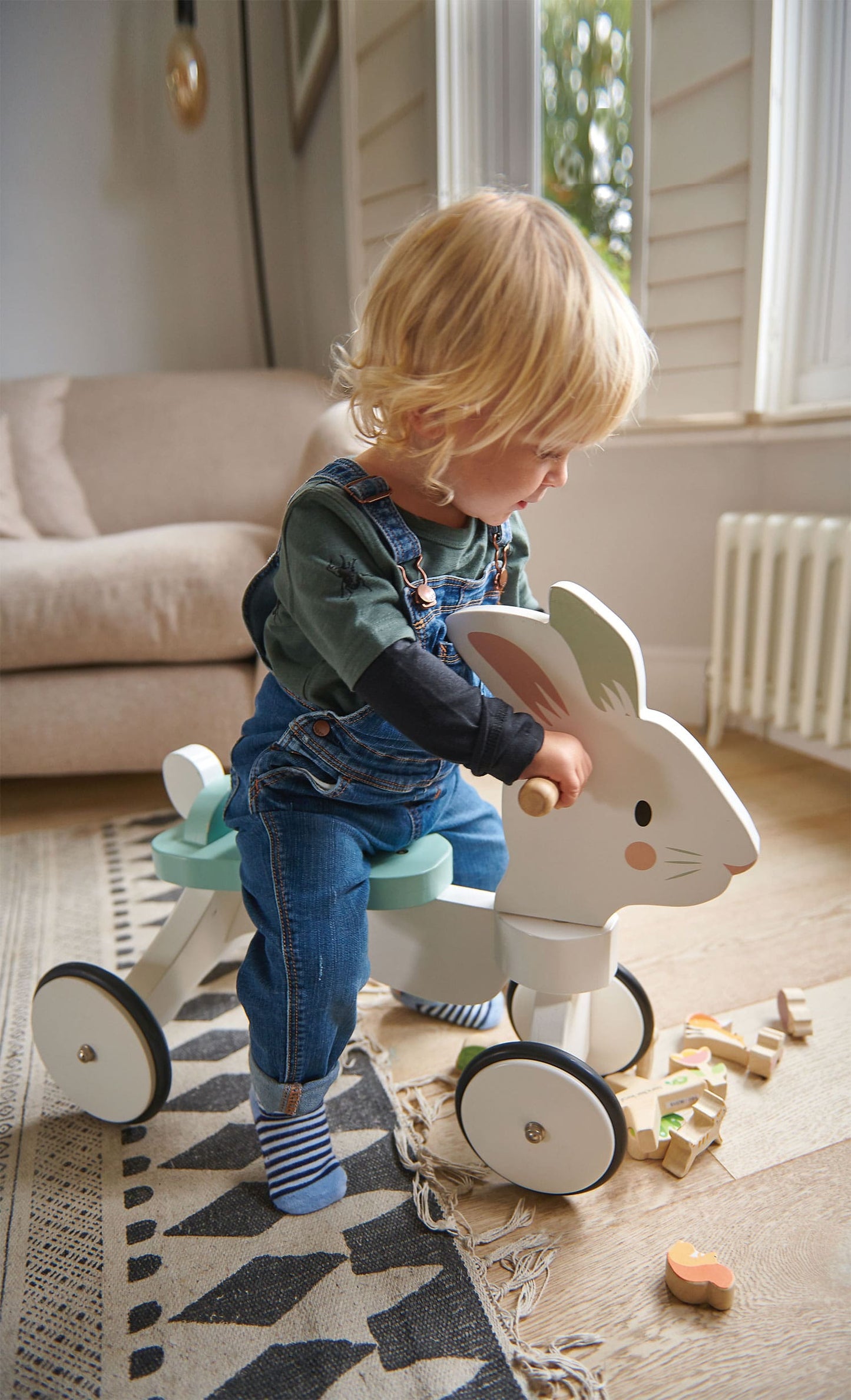 Child playing with Tender Leaf Running Rabbit Ride On