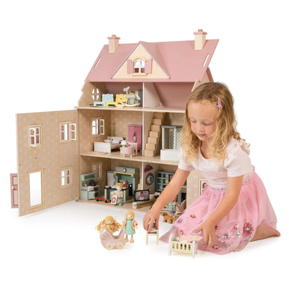 Child playing with Tender Leaf Alouette House and dolls on a white background