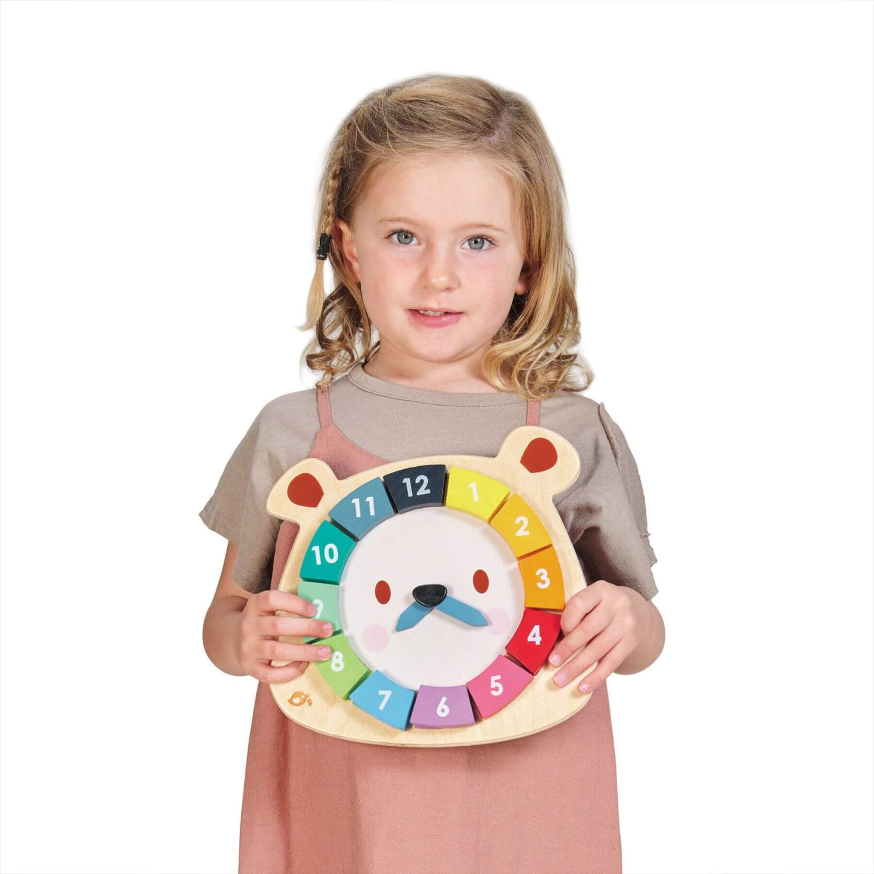 Child holding a colorful clock with a bear design on a white background
