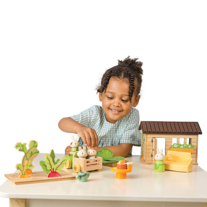 Child playing with Tender Leaf Bunny's Carrot Patch on a white surface