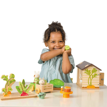 Child playing with Tender Leaf Bunny's Carrot Patch on a white background