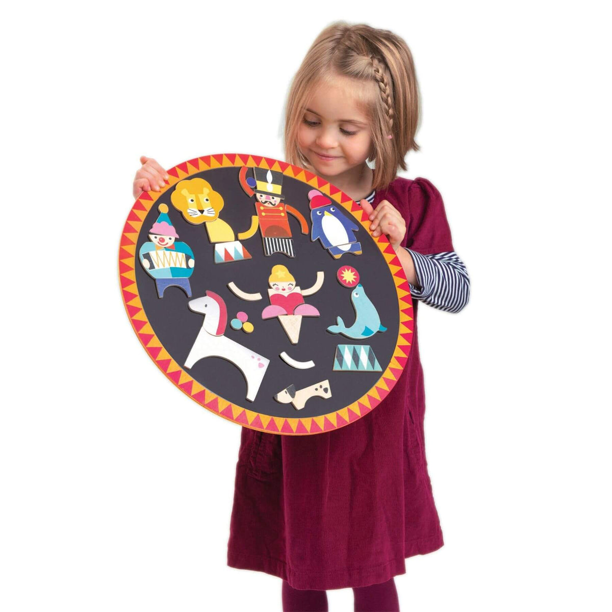 A young girl with blonde braided hair holds Tender Leaf Circus Night