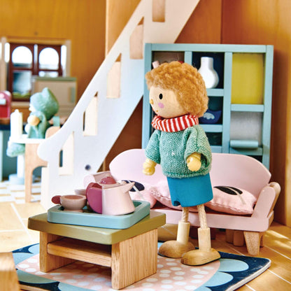 Doll in a cozy room with furniture and toys