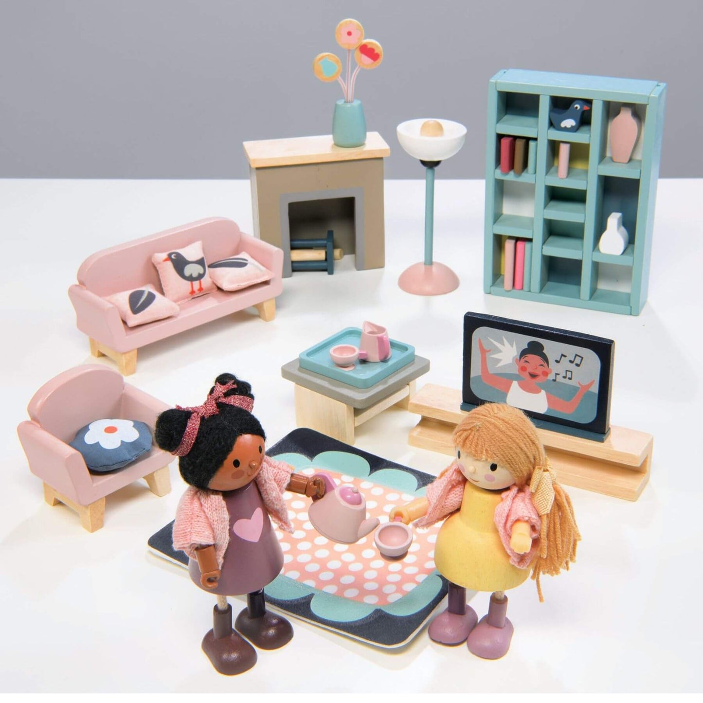 Toy living room set with dolls and furniture on a white background
