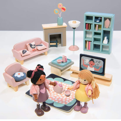 Toy living room set with dolls and furniture on a white background