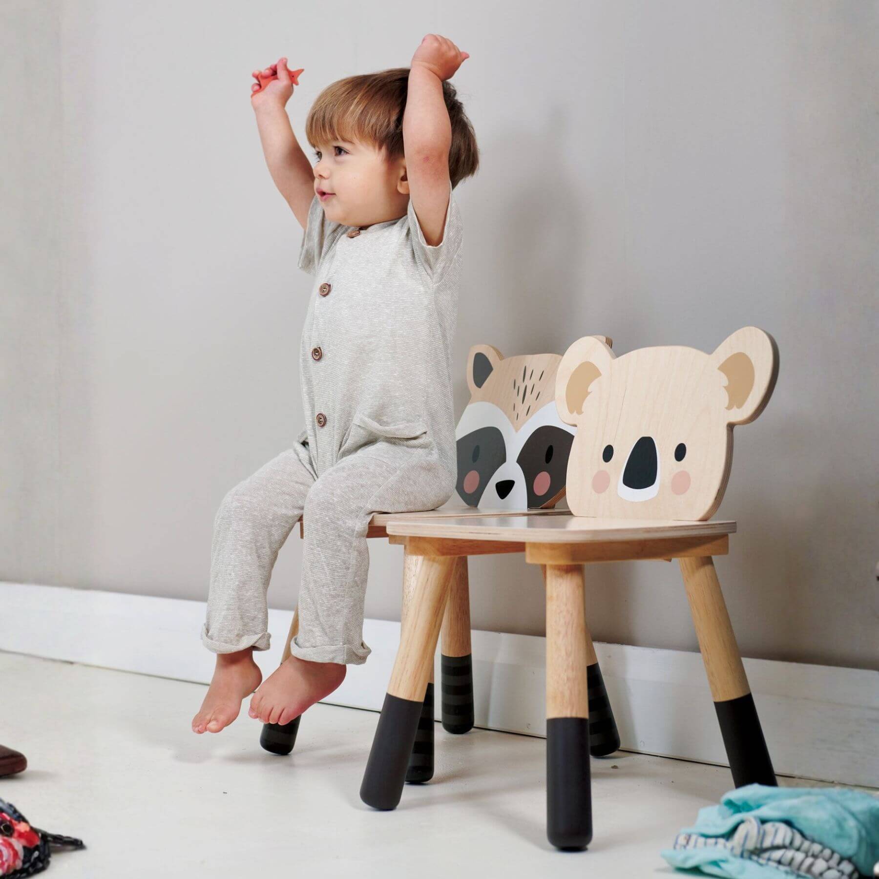 Boy sitting on Tender Leaf Forest Raccoon Chair