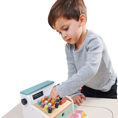 Child playing with Tender Leaf General Stores Till