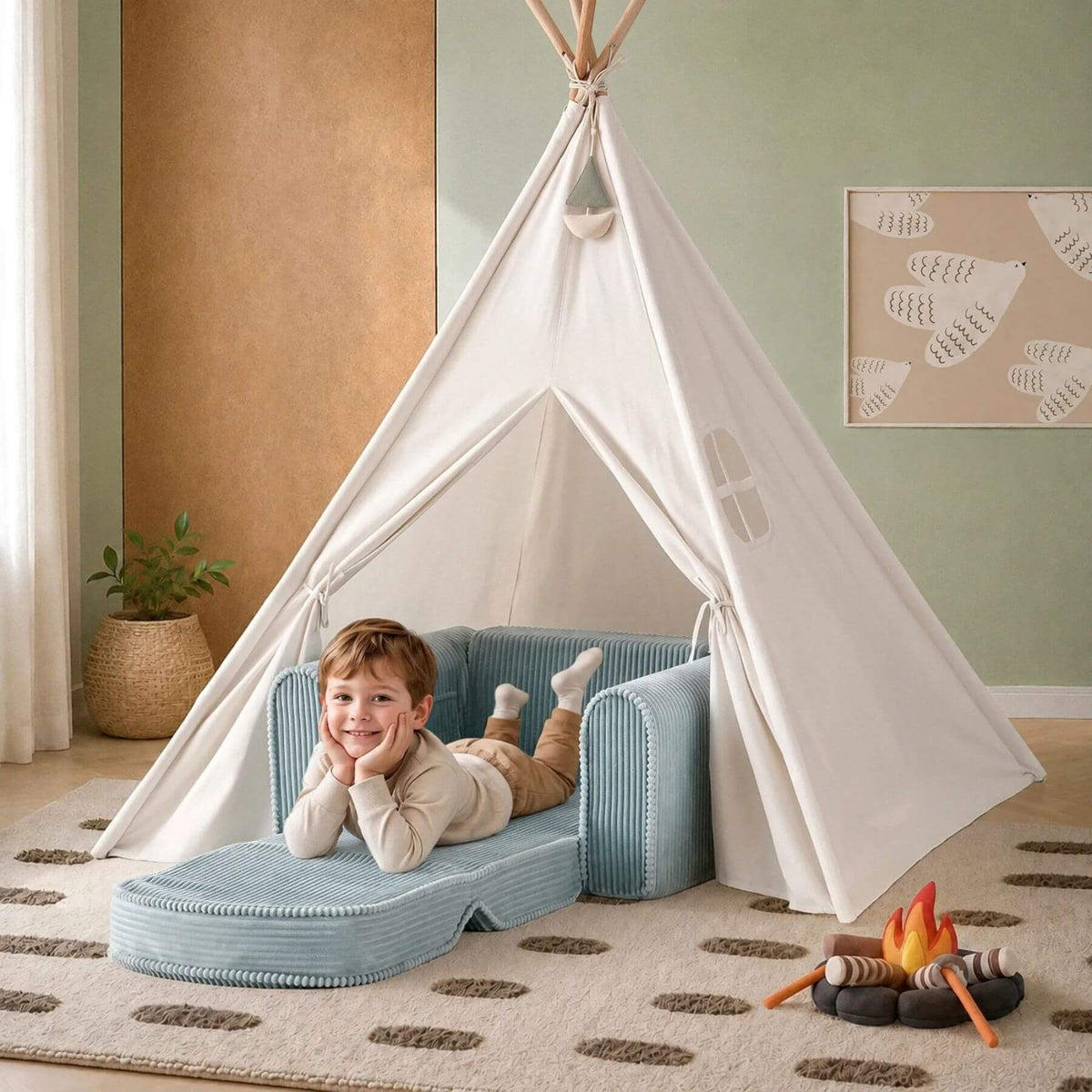 A child lies on Tiny Land® GentleSnug Corduroy Kid Chair - Teal inside a white fabric teepee tent in a styled children's room.