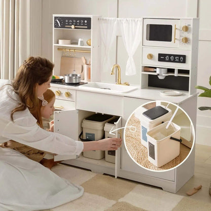 A woman and child use Tiny Land® Play Kitchen with Running Water - Iconic Aqua Kitchen in Cream. The scene includes a circular inset showing trash can bins inside the kitchen unit.