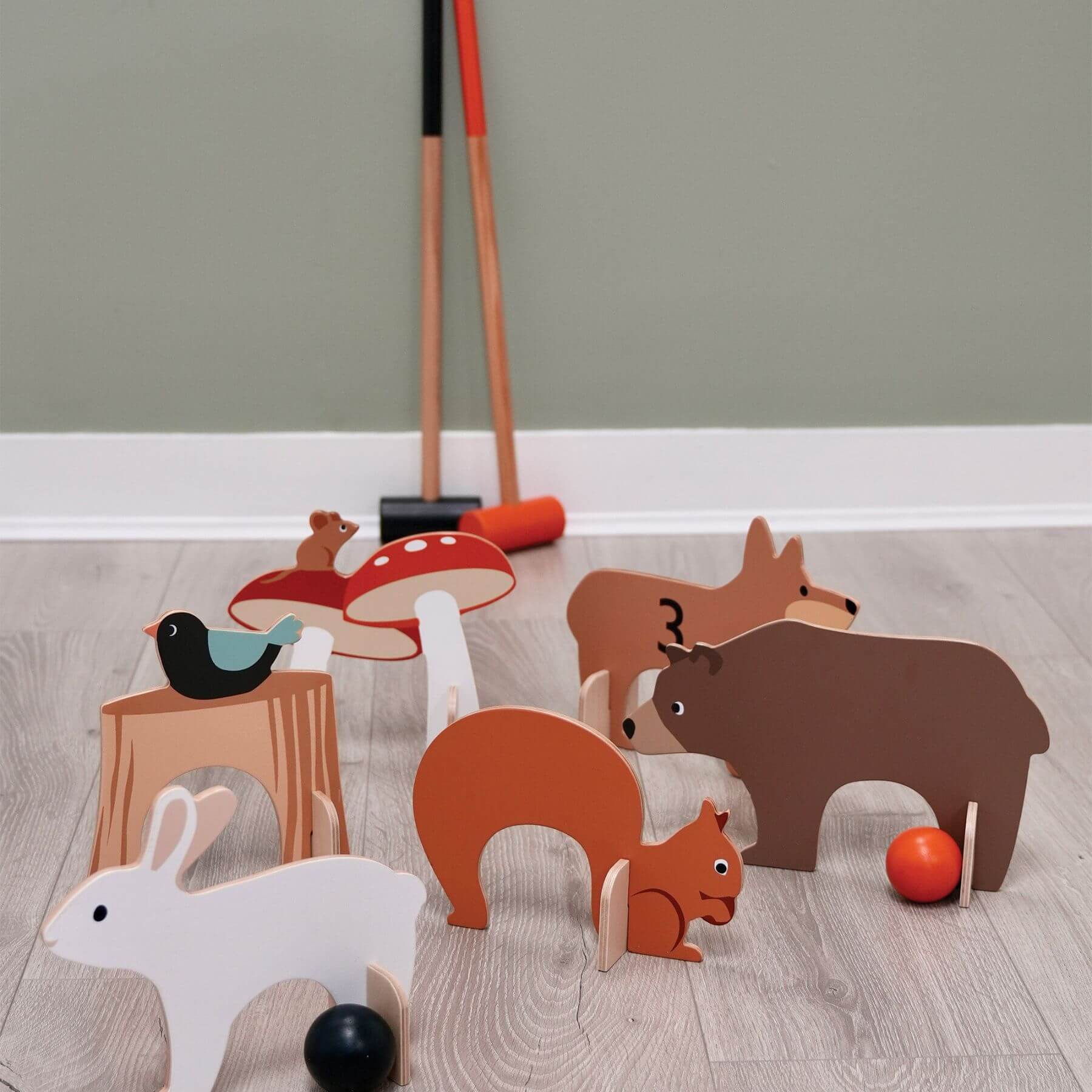 Tender Leaf Woodland Indoor Croquet Set on a wooden floor against a plain wall.