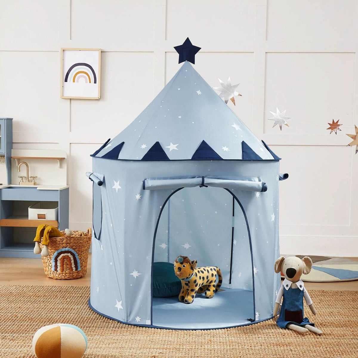Tiny Land® Kids Tent - Blue, set up in a child's bedroom next to a stuffed dog toy and a small stuffed animal.