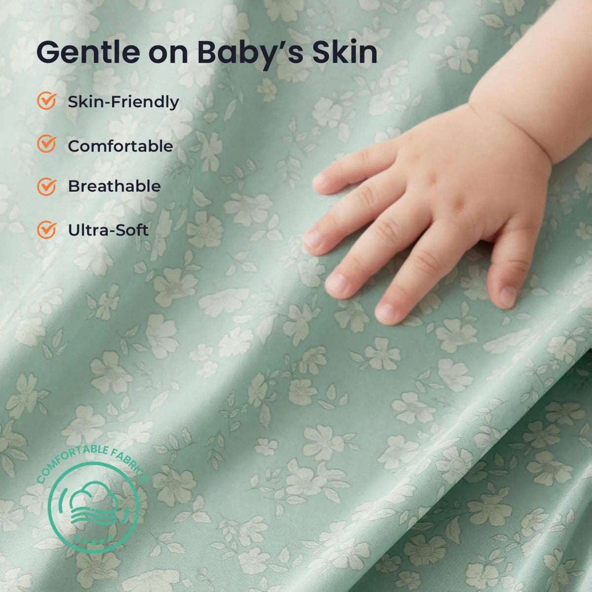 Hand touching a soft, green fabric with floral patterns and text highlighting its benefits for baby skin.