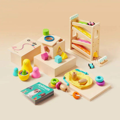 Collection of wooden toys with colorful shapes and educational materials on a beige background