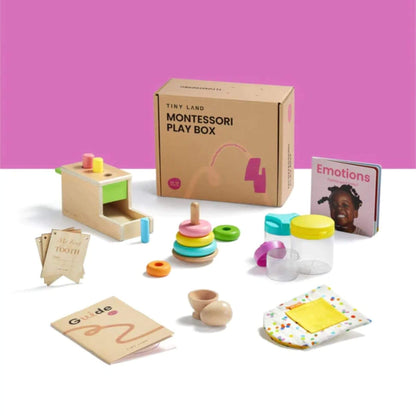 Montessori play box with educational toys and materials on a white surface against a pink background