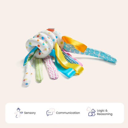 Colorful baby rattle toy on a light beige background