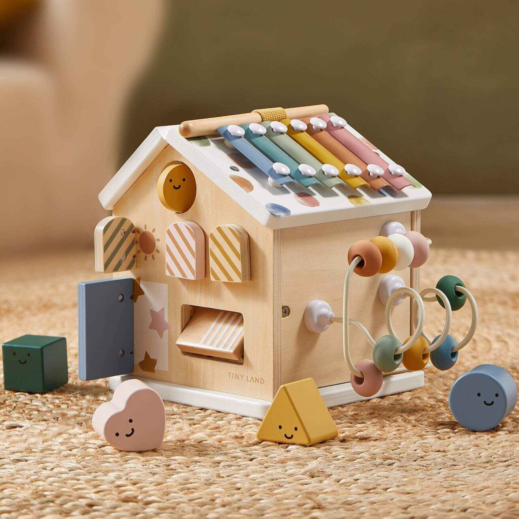 Tiny Land® Cottage Activity Cube - Morandi on a textured surface