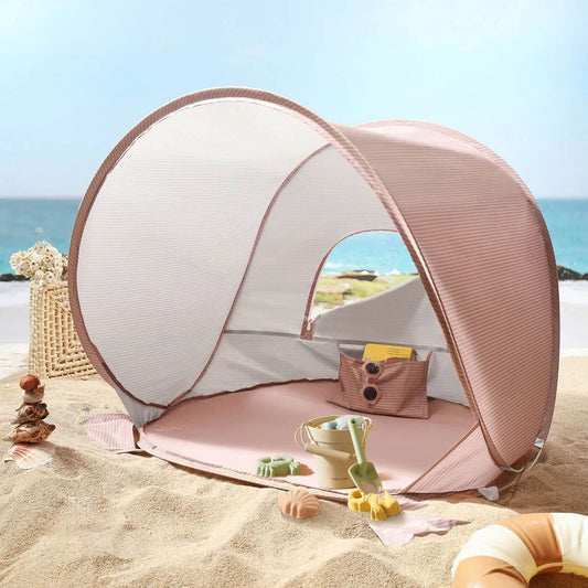 Portable beach tent on a sandy beach with ocean view