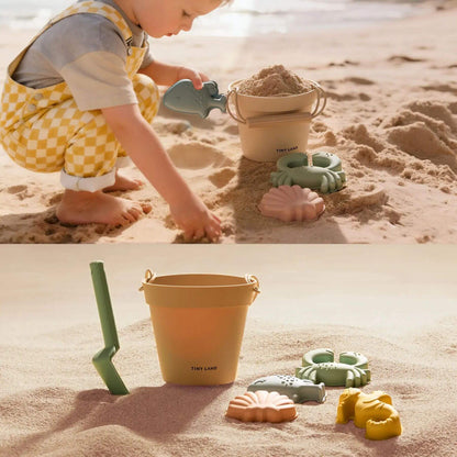Child playing with sand toys on a sandy beach