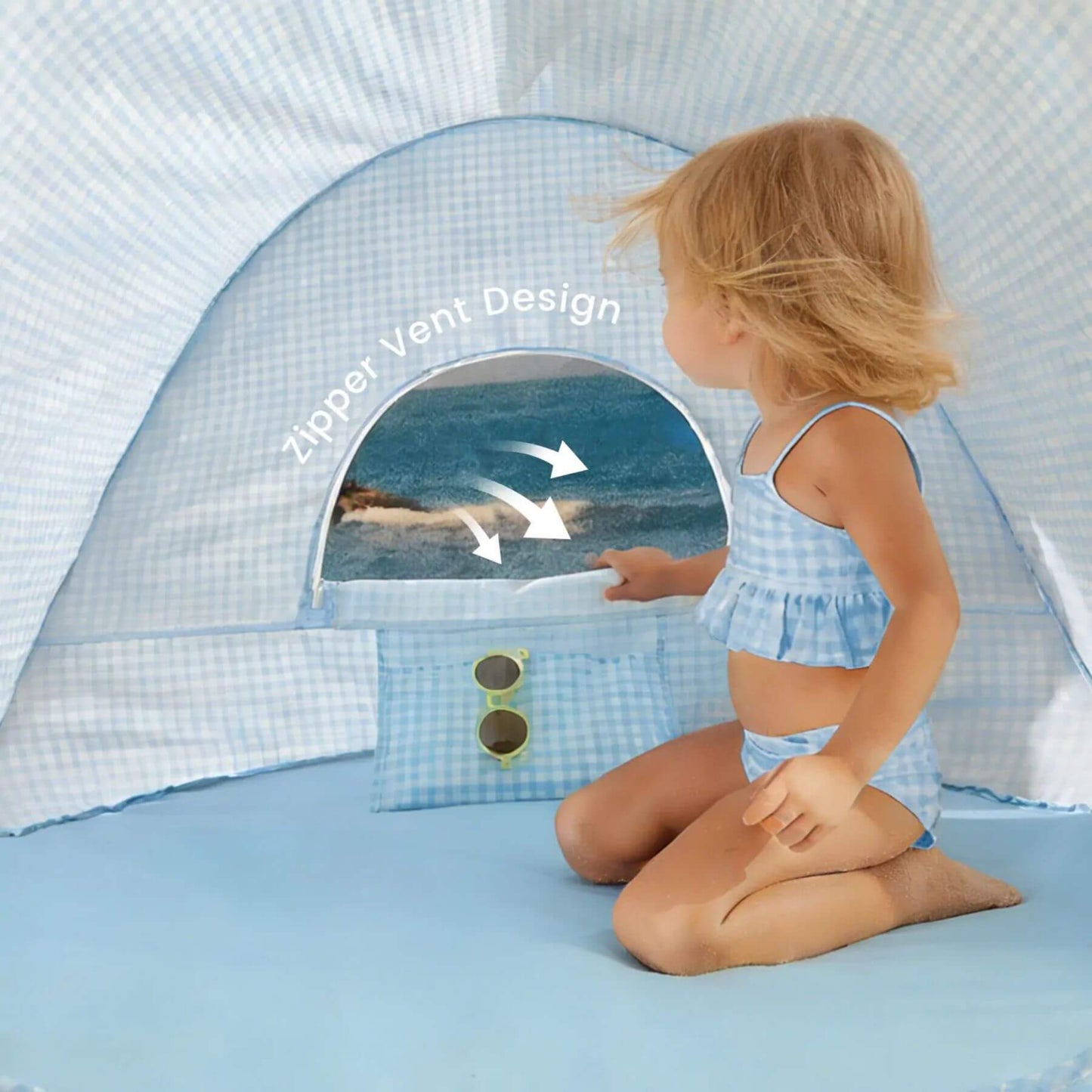 Child playing with a blue and white tent with zipper vent design.