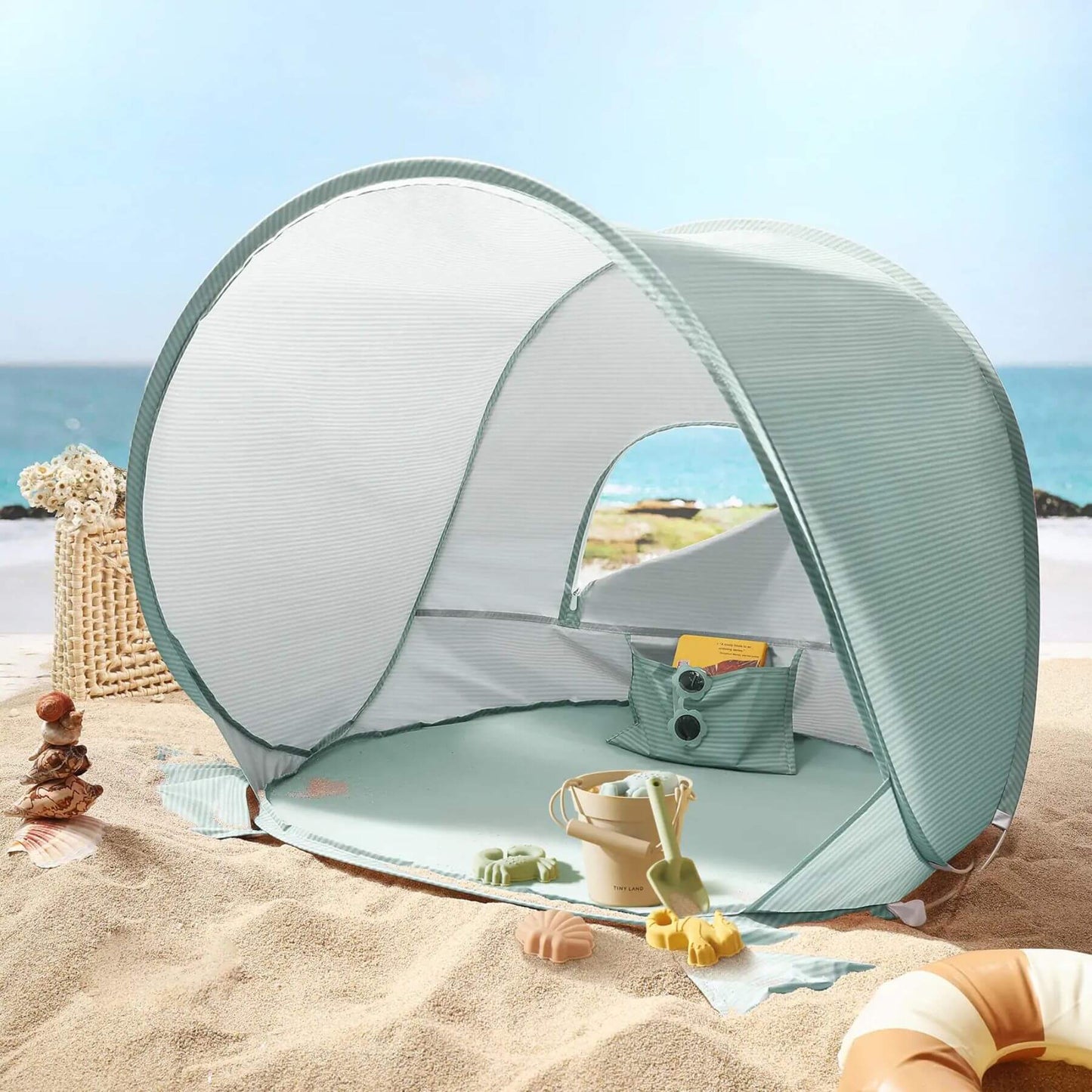 Portable beach tent on a sandy beach with ocean view