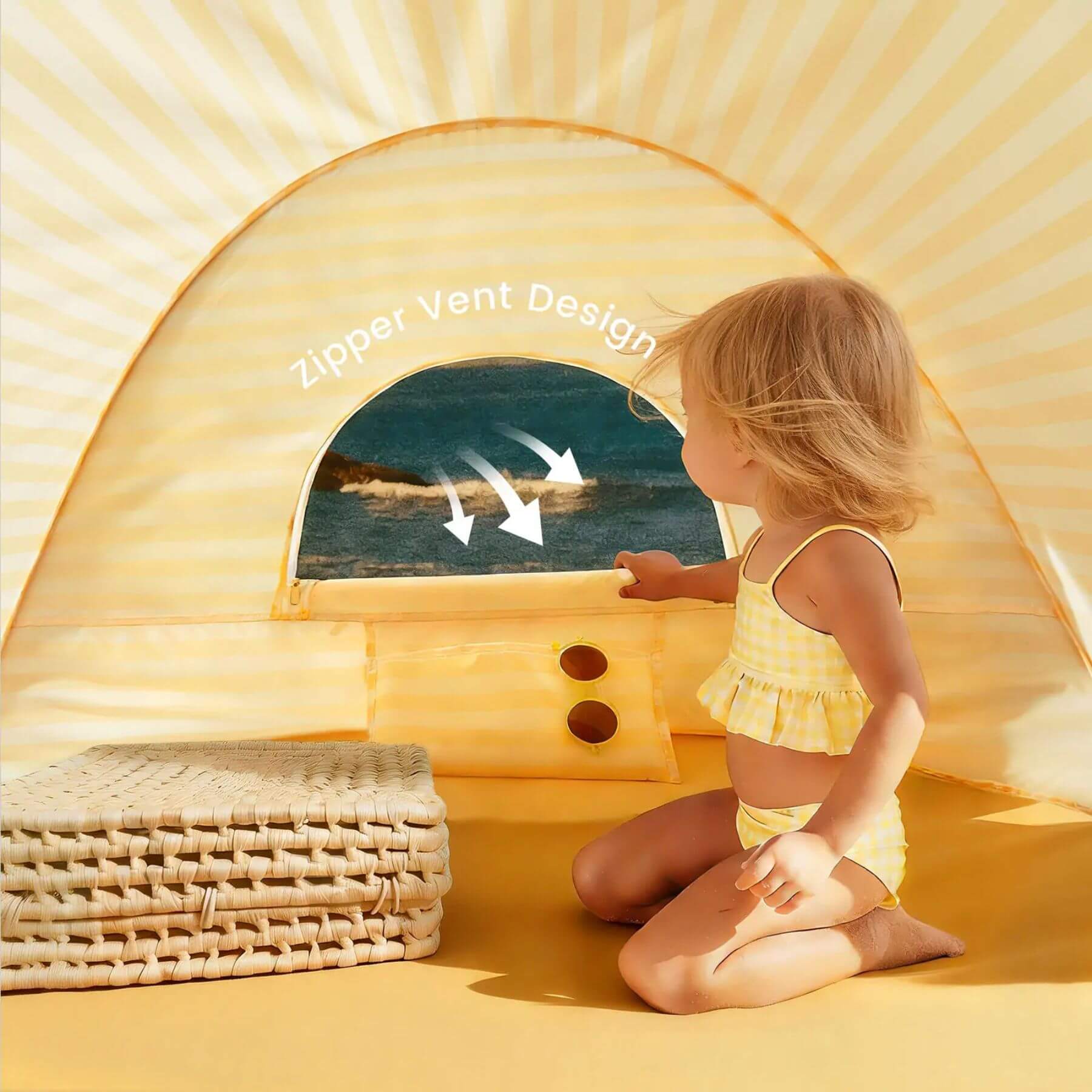 Child playing inside a yellow play tent with a zipper vent design.