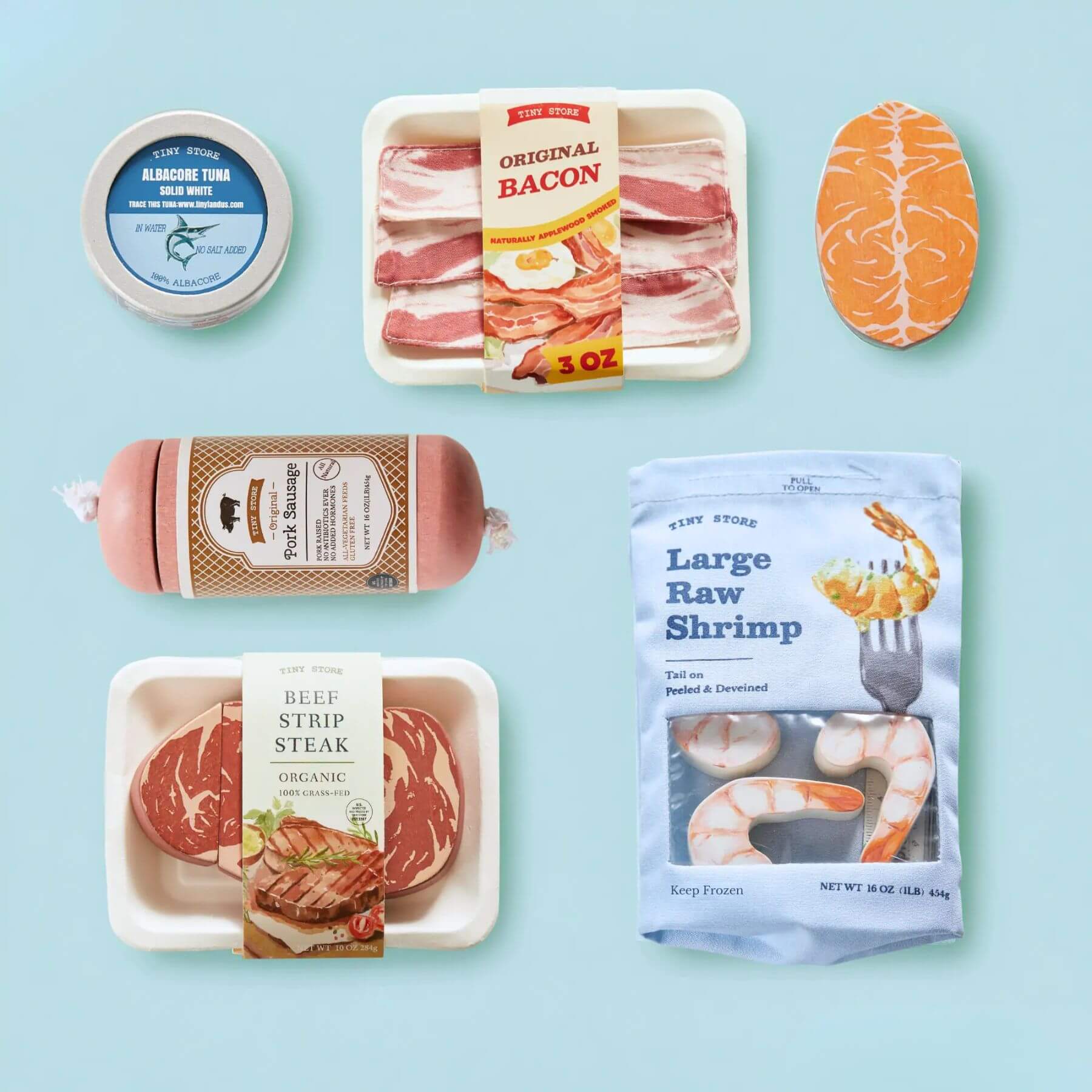Tiny Land® Organic Meat & Seafood Pack on a light blue background