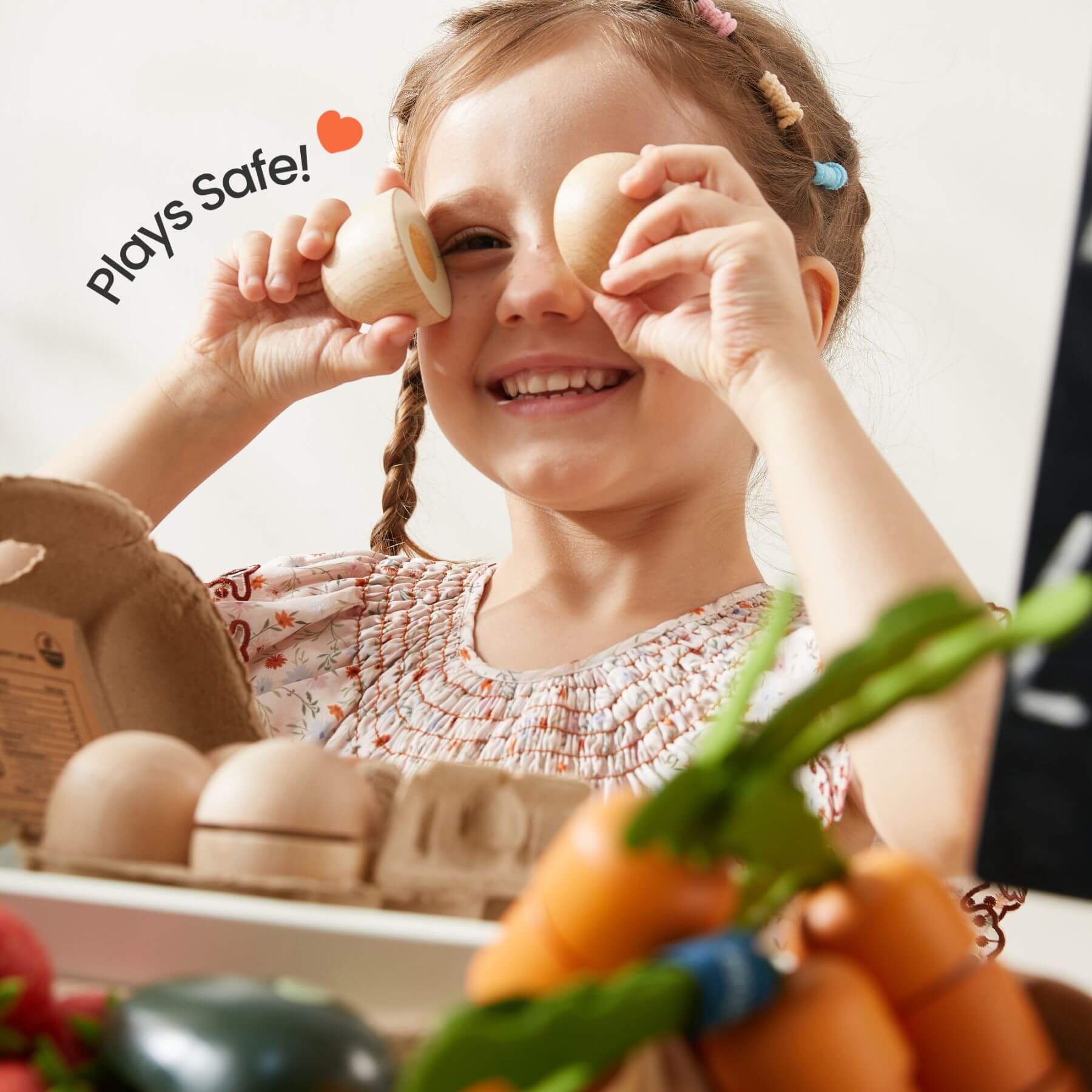 Child playing with wooden toys and vegetables, with 'Plays Safe!' text.