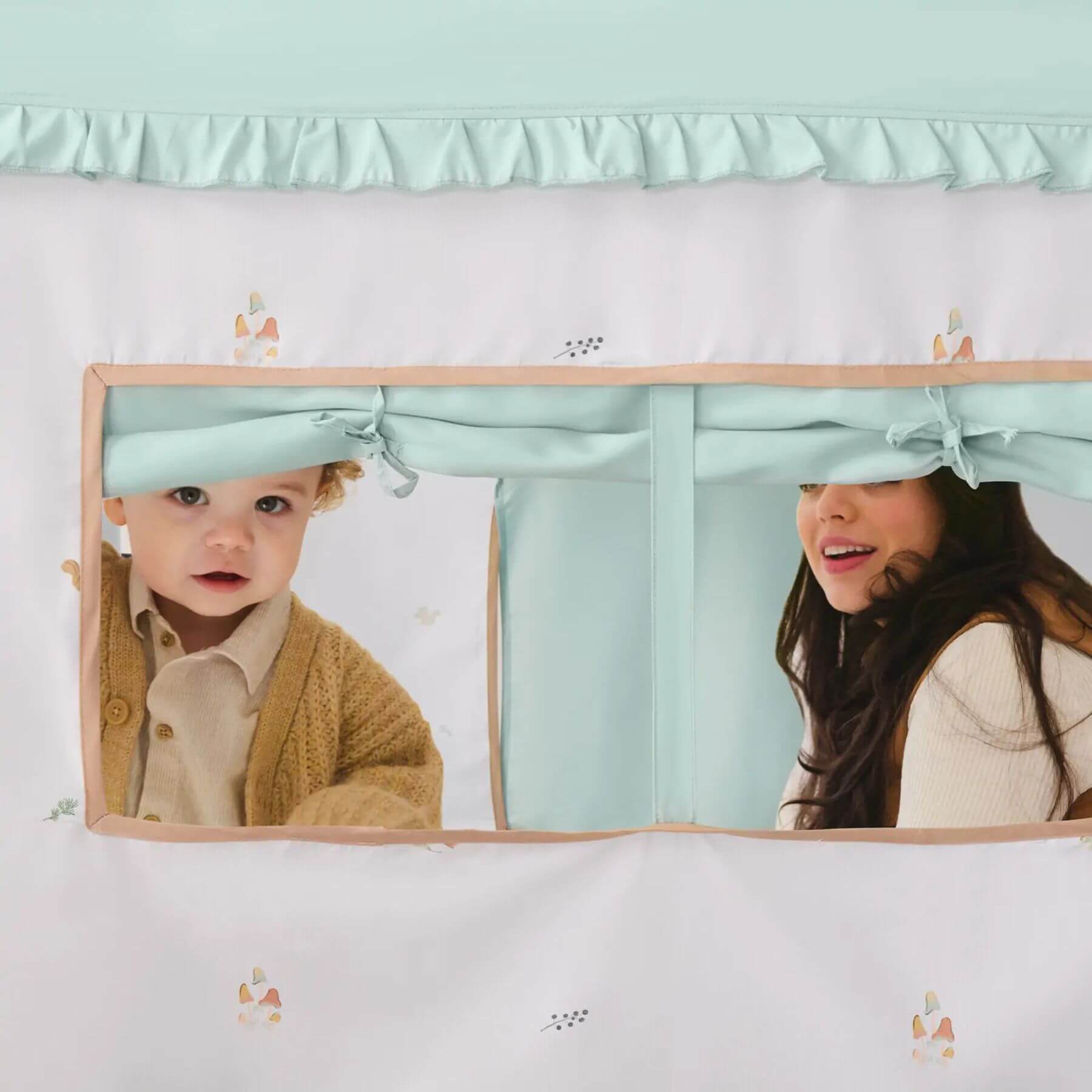 Two children peeking out from inside Tiny Land® Playhouse Tent