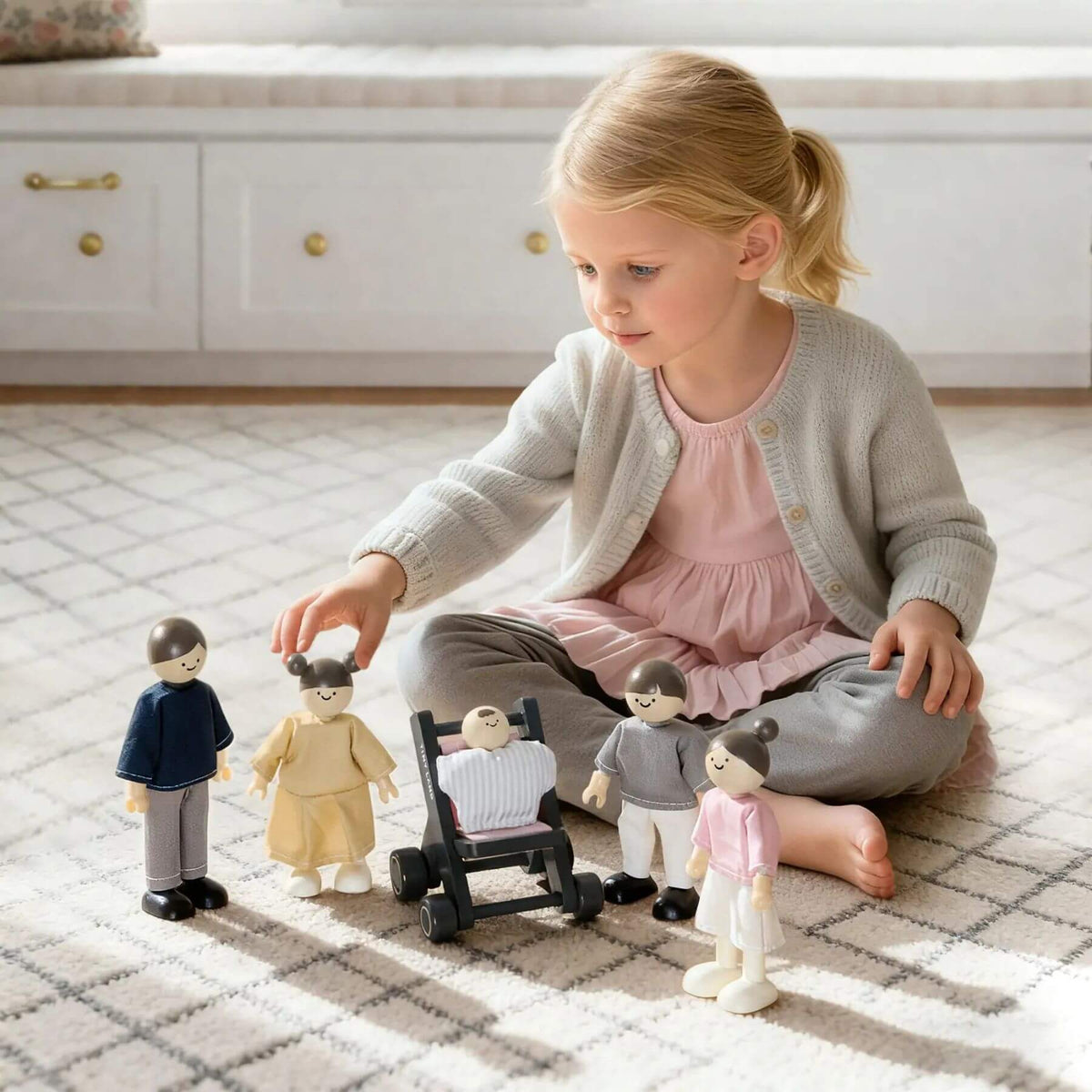 Young girl playing with toy figures on a checkered floor.