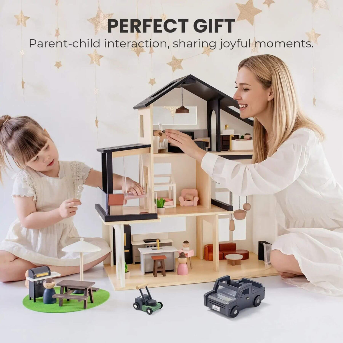 Woman and child playing with a dollhouse and accessories on a light background.
