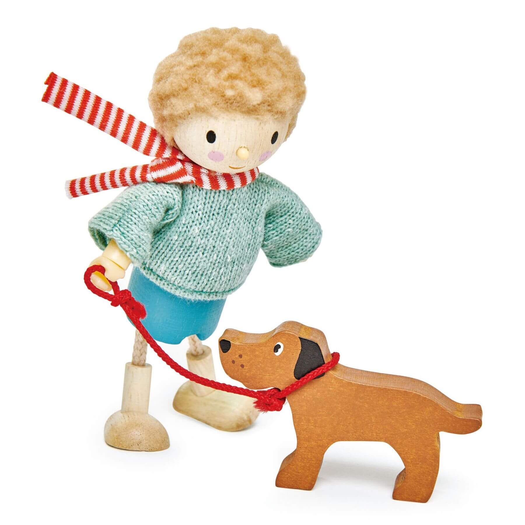 Wooden toy figure of a boy with a dog on a white background