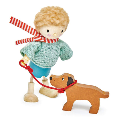 Wooden toy figure of a boy with a dog on a white background