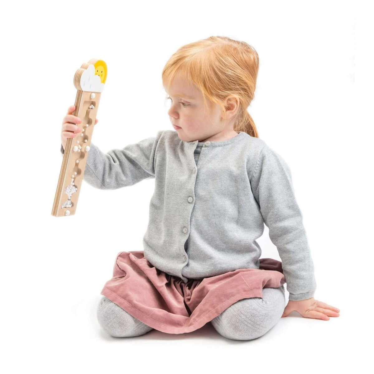 Child playing with a wooden toy on a white background
